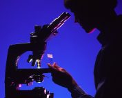 scientist with microscope